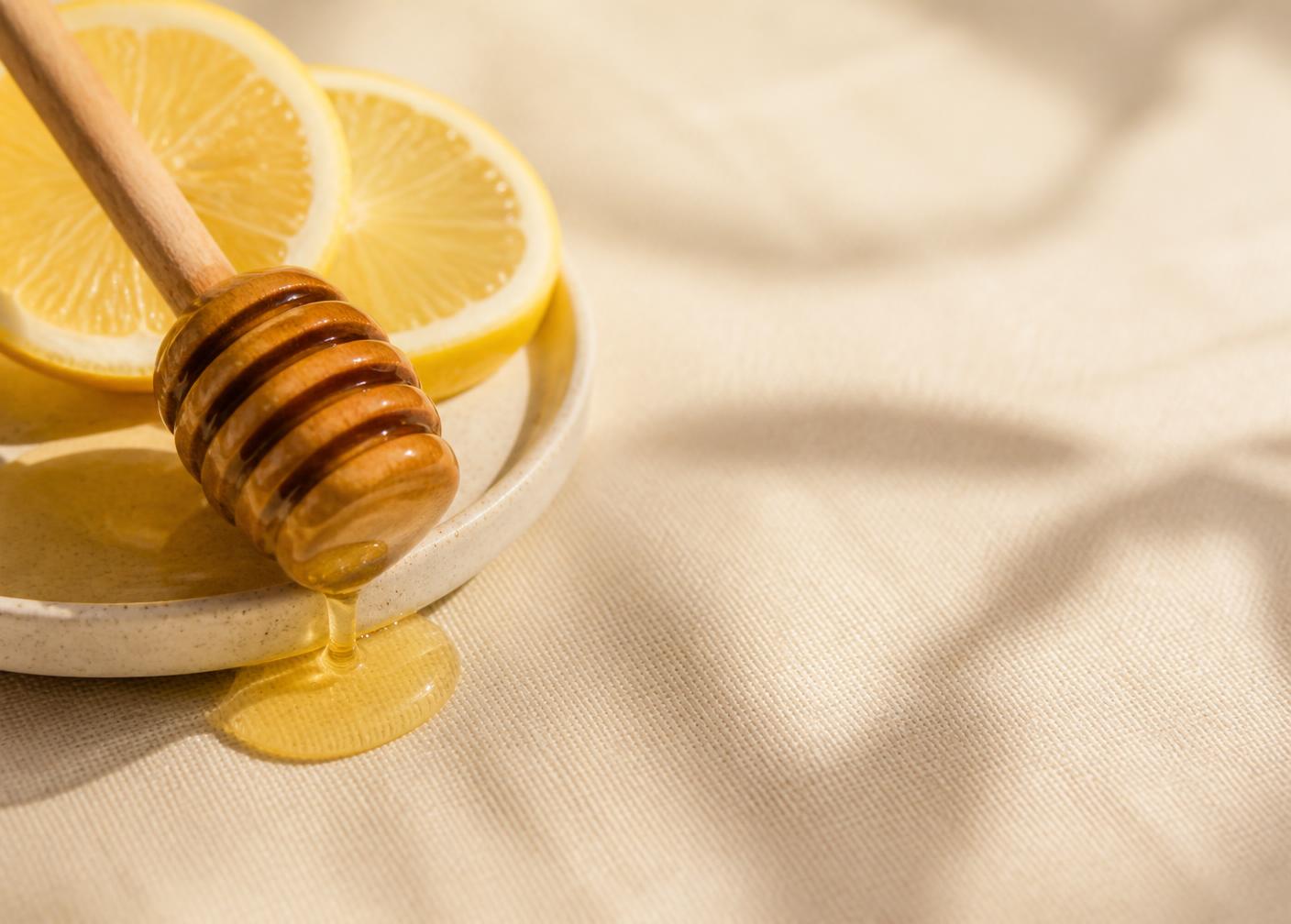 Honey & Lemon ingredients styled in a warm natural setting